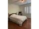 Bedroom featuring hardwood floors, shutters, and neutral wall color at 4748 Arcado Sw Rd, Lilburn, GA 30047