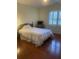 Bedroom features hardwood floors and a bright window with window treatments at 4748 Arcado Sw Rd, Lilburn, GA 30047