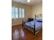 Bedroom featuring hardwood floors, shutters, and neutral wall color at 4748 Arcado Sw Rd, Lilburn, GA 30047