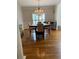 Open-concept dining room with a chandelier, a bar, and beautiful hardwood floors at 4748 Arcado Sw Rd, Lilburn, GA 30047