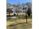 Beautiful two-story home featuring mature trees and manicured lawn at 4748 Arcado Sw Rd, Lilburn, GA 30047