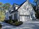 Spacious home with a two-car garage, white brick facade, and well-maintained landscaping at 4748 Arcado Sw Rd, Lilburn, GA 30047