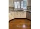 Bright kitchen with white cabinets, granite countertops, stainless steel appliances, and hardwood floors at 4748 Arcado Sw Rd, Lilburn, GA 30047
