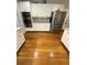 Bright kitchen features stainless steel appliances, light cabinets, and gleaming hardwood floors at 4748 Arcado Sw Rd, Lilburn, GA 30047