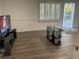 Bright living room features hardwood floors, neutral walls, and natural light from the large window and glass door at 4748 Arcado Sw Rd, Lilburn, GA 30047