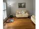 Cozy sitting room filled with natural light, featuring hardwood floors and comfortable seating at 4748 Arcado Sw Rd, Lilburn, GA 30047