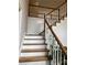 Bright staircase features white railing, wooden steps, and natural light at 4748 Arcado Sw Rd, Lilburn, GA 30047
