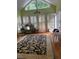 Bright sun room with shuttered windows and doors and decorative fish wall decor at 4748 Arcado Sw Rd, Lilburn, GA 30047