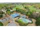 Aerial view of tennis courts, pool, and play area surrounded by mature trees and manicured landscaping at 1060 Meadow Brook Dr, Woodstock, GA 30188