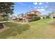 Sprawling backyard with outdoor fireplace, deck, and lush lawn at 1060 Meadow Brook Dr, Woodstock, GA 30188