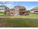 Large backyard with stone fireplace, deck, and ample green space at 1060 Meadow Brook Dr, Woodstock, GA 30188