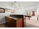 Elegant basement bar area with custom cabinetry, granite countertop, and nearby billiards room, perfect for entertaining at 1060 Meadow Brook Dr, Woodstock, GA 30188