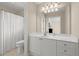 Clean and bright bathroom with a toilet, vanity, framed mirror, and shower featuring a white shower curtain at 1060 Meadow Brook Dr, Woodstock, GA 30188