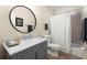 Neutral bathroom with a shower-tub combination and gray vanity at 1060 Meadow Brook Dr, Woodstock, GA 30188
