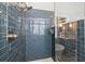 Modern bathroom featuring glass shower and stylish blue tiling at 1060 Meadow Brook Dr, Woodstock, GA 30188
