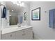 Bright bathroom with a large mirror, white cabinets, and a shower with glass doors and blue towels at 1060 Meadow Brook Dr, Woodstock, GA 30188