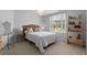 Cozy bedroom with natural light, a queen-size bed, and a decorative bookshelf and stylish decor at 1060 Meadow Brook Dr, Woodstock, GA 30188