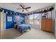 Baseball-themed bedroom with a bed, colorful decor, ceiling fan, window, and built-in storage at 1060 Meadow Brook Dr, Woodstock, GA 30188