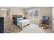 Bedroom featuring a cozy bed, rocking chair, a view of a window and stylish interior at 1060 Meadow Brook Dr, Woodstock, GA 30188