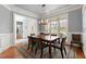 Formal dining room with wood floors, large windows, and elegant chandelier at 1060 Meadow Brook Dr, Woodstock, GA 30188