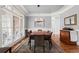 Dining room with wood floors, large windows, chandelier, and gray wall paint at 1060 Meadow Brook Dr, Woodstock, GA 30188