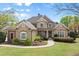 Charming stone and siding home featuring a manicured lawn and inviting front porch at 1060 Meadow Brook Dr, Woodstock, GA 30188