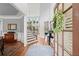 Elegant foyer with hardwood floors, staircase, and views into other rooms at 1060 Meadow Brook Dr, Woodstock, GA 30188