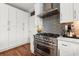 Close up of the kitchen featuring stainless steel oven, range, and vent hood at 1060 Meadow Brook Dr, Woodstock, GA 30188