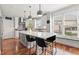 Open kitchen featuring an island with seating, modern light fixtures, and stainless steel appliances at 1060 Meadow Brook Dr, Woodstock, GA 30188