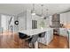 Bright kitchen featuring an island with seating, stainless steel appliances, and white cabinets at 1060 Meadow Brook Dr, Woodstock, GA 30188