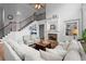 Open living room with large fireplace, staircase, and cozy seating area at 1060 Meadow Brook Dr, Woodstock, GA 30188