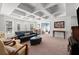 Spacious living room with coffered ceilings, natural light, and a comfortable seating area with carpeting at 1060 Meadow Brook Dr, Woodstock, GA 30188