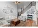 Spacious living room with a fireplace, staircase, and hardwood floors at 1060 Meadow Brook Dr, Woodstock, GA 30188