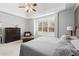 Spacious main bedroom featuring tray ceiling, neutral colors, and a window seat at 1060 Meadow Brook Dr, Woodstock, GA 30188