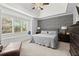 Cozy main bedroom featuring tray ceiling, neutral colors, and a window seat at 1060 Meadow Brook Dr, Woodstock, GA 30188