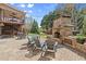 Relaxing backyard with a beautiful stone fireplace, patio, and seating, perfect for outdoor entertaining at 1060 Meadow Brook Dr, Woodstock, GA 30188