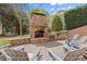 Charming stone outdoor fireplace and patio area with comfortable seating, ideal for outdoor gatherings and relaxation at 1060 Meadow Brook Dr, Woodstock, GA 30188