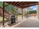 Spacious outdoor patio area with stone flooring, outdoor fireplace, and room for entertaining at 1060 Meadow Brook Dr, Woodstock, GA 30188