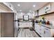 Modern kitchen with stainless steel appliances, granite countertops, and ample cabinet space at 1714 Highland Pl, Decatur, GA 30035