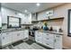 Well-equipped kitchen featuring stainless steel appliances, granite countertops, and white cabinetry at 1714 Highland Pl, Decatur, GA 30035