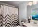 Bathroom featuring a shower with a gray chevron shower curtain and modern fixtures at 5101 Barrington Trace Dr, Atlanta, GA 30331