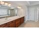 Bright bathroom featuring double sinks with a large mirror, soaking tub, and glass-enclosed shower at 5101 Barrington Trace Dr, Atlanta, GA 30331