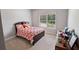Bright bedroom with colorful bedding, a large window, and ample space for storage at 5101 Barrington Trace Dr, Atlanta, GA 30331