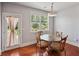 Cozy breakfast nook with glass table, hardwood floors, natural lighting and door to deck at 5101 Barrington Trace Dr, Atlanta, GA 30331