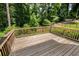 A spacious wooden deck with views of the fenced backyard and surrounding lush greenery at 5101 Barrington Trace Dr, Atlanta, GA 30331