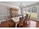 Dining room with natural light, crown molding, hardwood floors, and traditional china cabinet at 5101 Barrington Trace Dr, Atlanta, GA 30331
