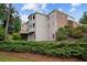 The back of the home showcases a blend of brick and siding, complemented by mature landscaping and a walkout deck at 5101 Barrington Trace Dr, Atlanta, GA 30331