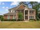 Charming two-story brick home with a well-manicured lawn and mature trees at 5101 Barrington Trace Dr, Atlanta, GA 30331