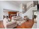 Open living room with fireplace and hardwood floors flows to kitchen with island and stainless appliances at 5101 Barrington Trace Dr, Atlanta, GA 30331