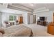 Large main bedroom with lots of natural light, seating area, neutral walls, carpet and a tray ceiling at 5101 Barrington Trace Dr, Atlanta, GA 30331